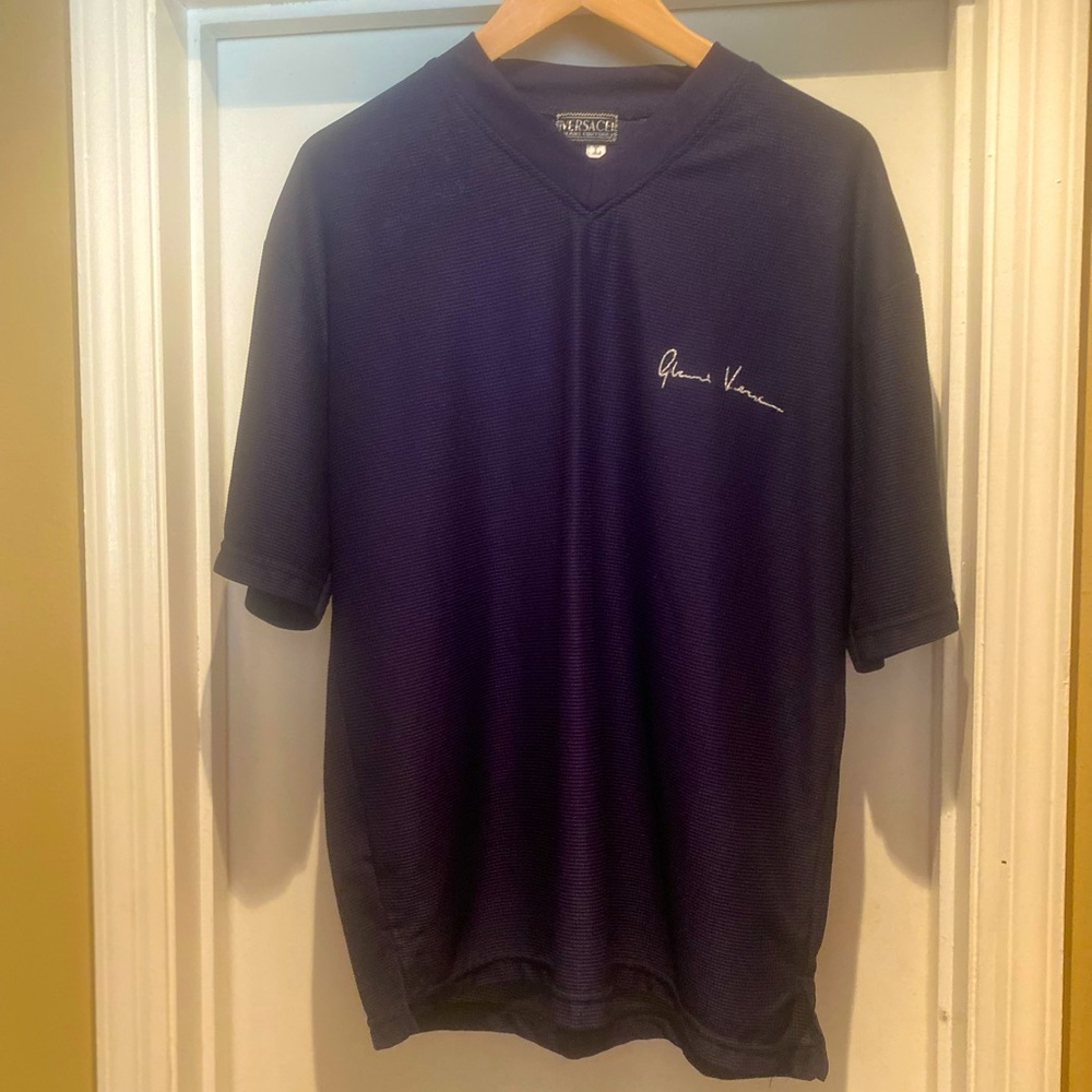 Here is a Vintage Versace Tee. Dark Blue with designer signature on the front!